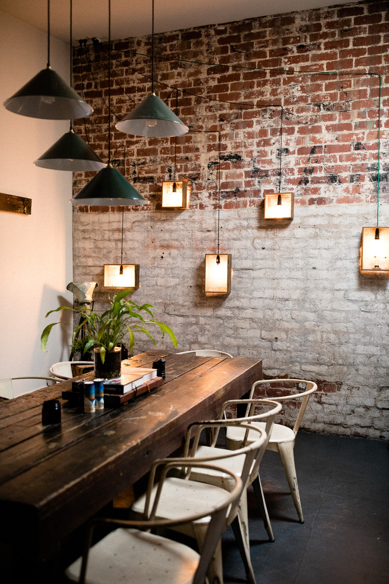 cafe interior of Platform Espresso Glen Iris with brick wall and light boxes on wall