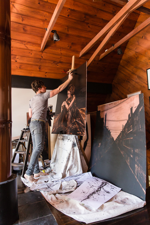 Artist Gerard Russo working in his studio on large piece of copper on an easel
