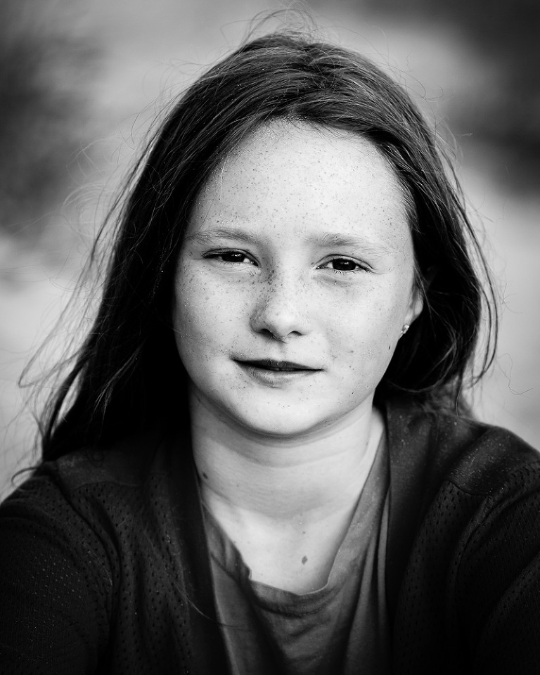 Portrait of girl with mona lisa expression facing camera