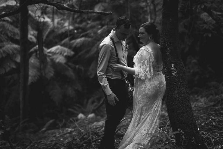 bride and groom showing comfort and shy emotion with each other in ferny forest